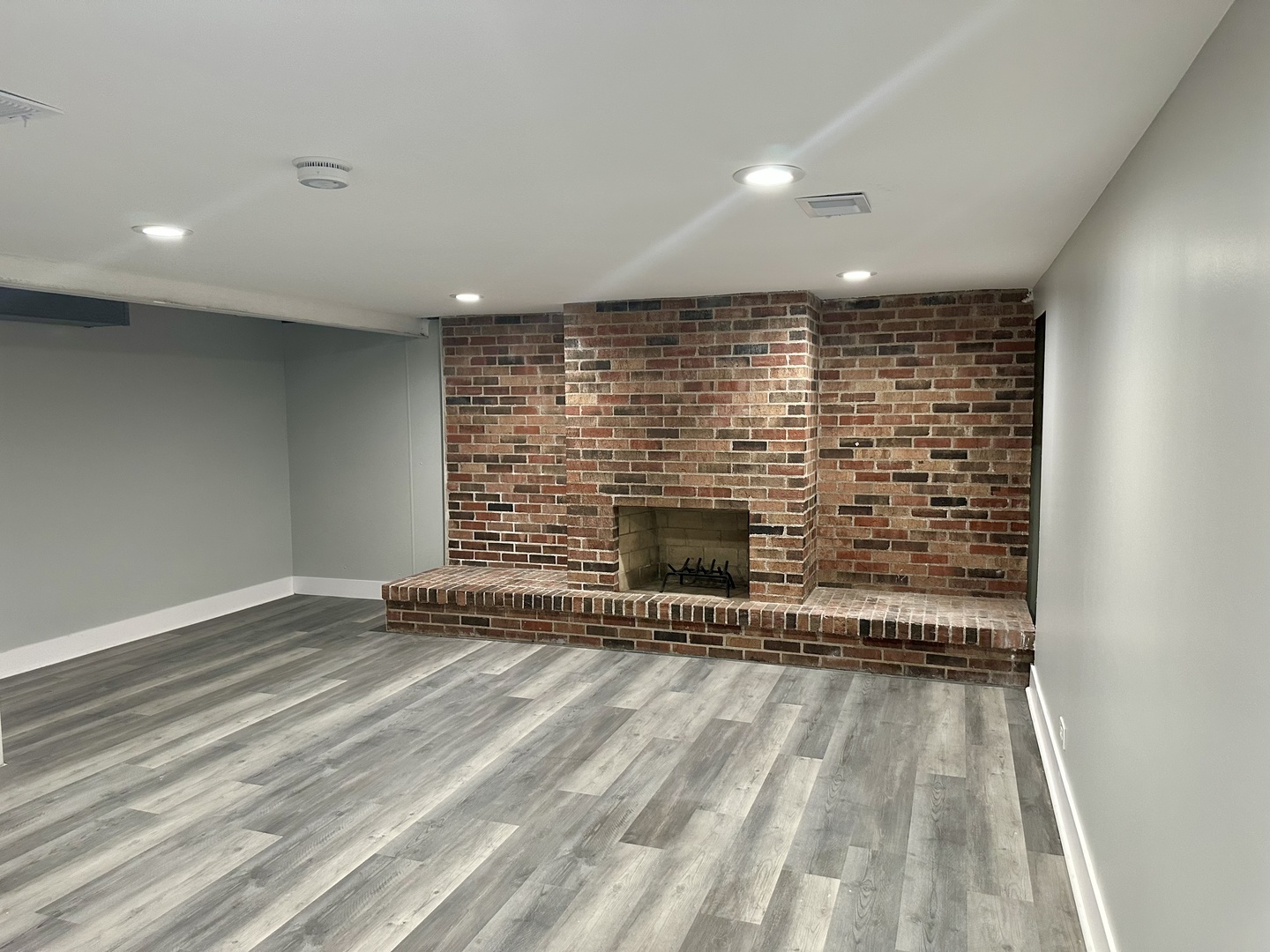 Undisclosed Address Glenwood, IL 60425 - Photo 13 of 17 an empty room with wooden floor and a fireplace