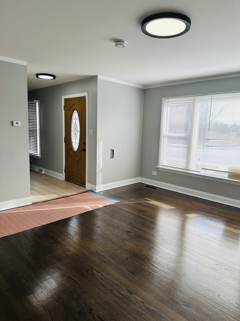 Undisclosed Address Glenwood, IL 60425 - Photo 5 of 17 a view of a livingroom with wooden floor and window