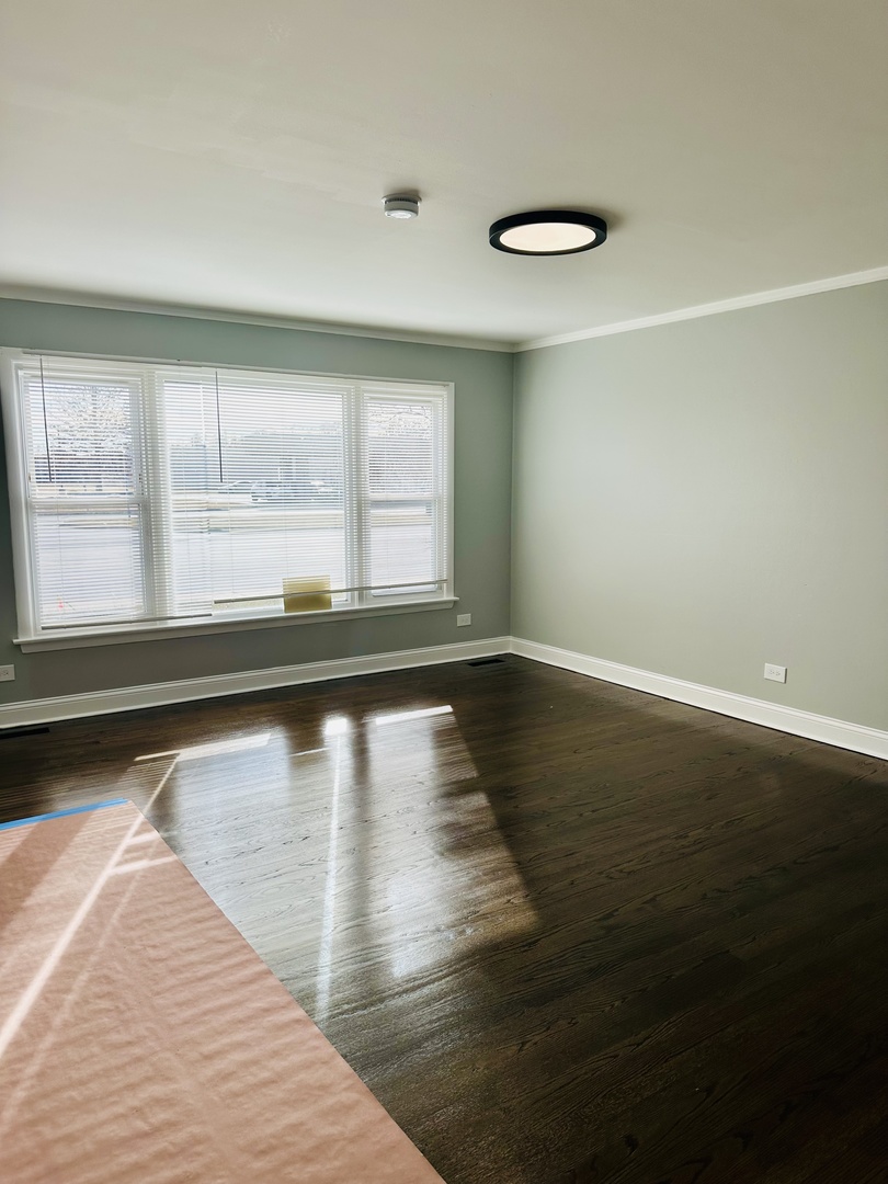 Undisclosed Address Glenwood, IL 60425 - Photo 6 of 17 a view of empty room with wooden floor and fan