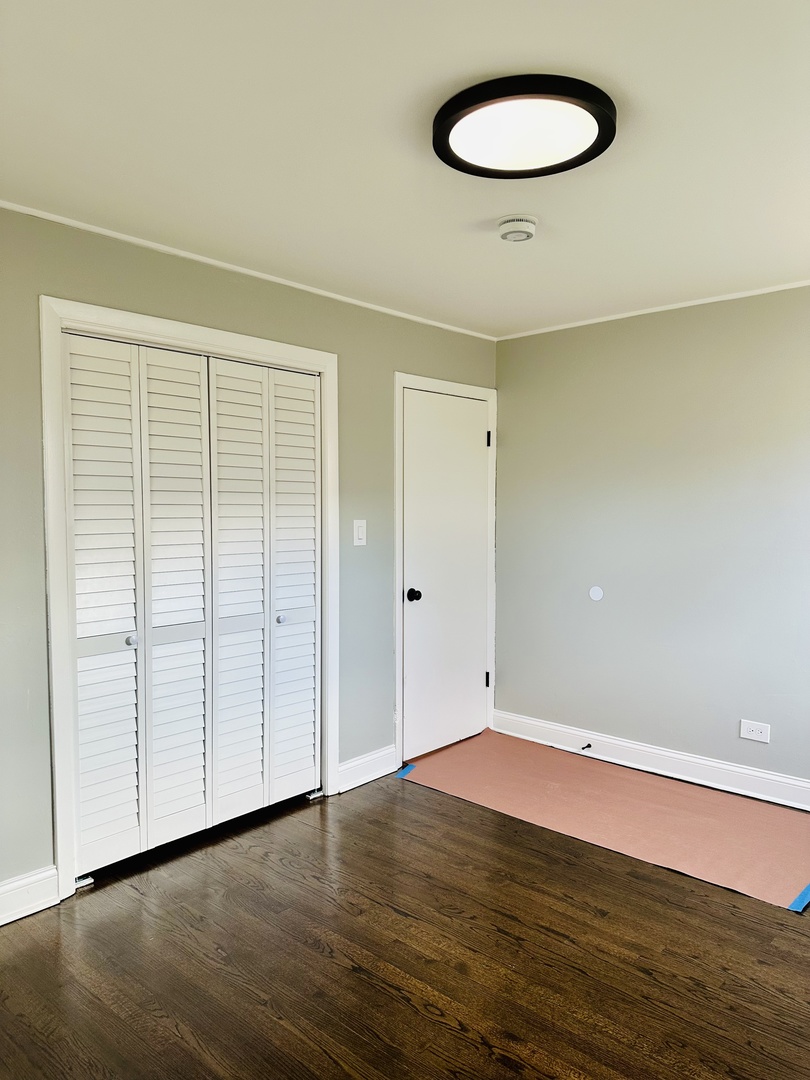 Undisclosed Address Glenwood, IL 60425 - Photo 7 of 17 an empty room with wooden floor and natural light