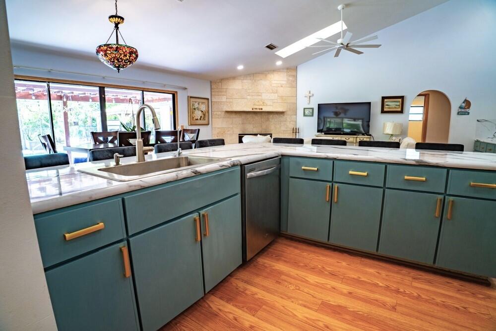 a kitchen with stainless steel appliances granite countertop sink stove and refrigerator
