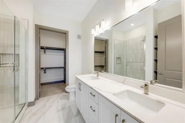 a spacious bathroom with a granite countertop sink mirror and double