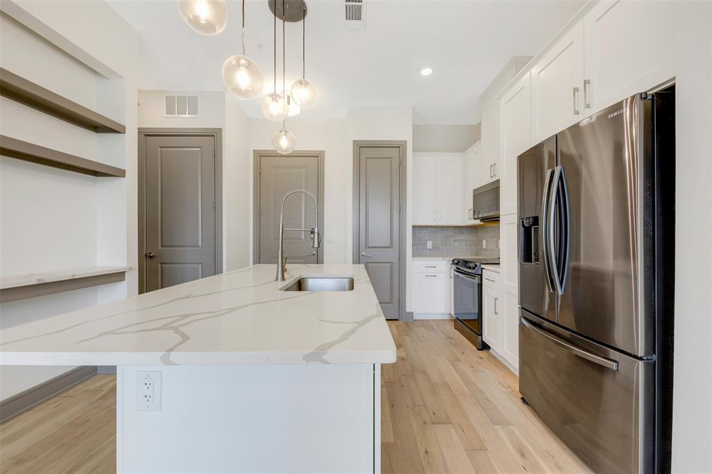 2700 Old Denton Road, Unit 2236 Carrollton, TX 75007 - Photo 3 of 28 a kitchen with stainless steel appliances a refrigerator sink and microwave