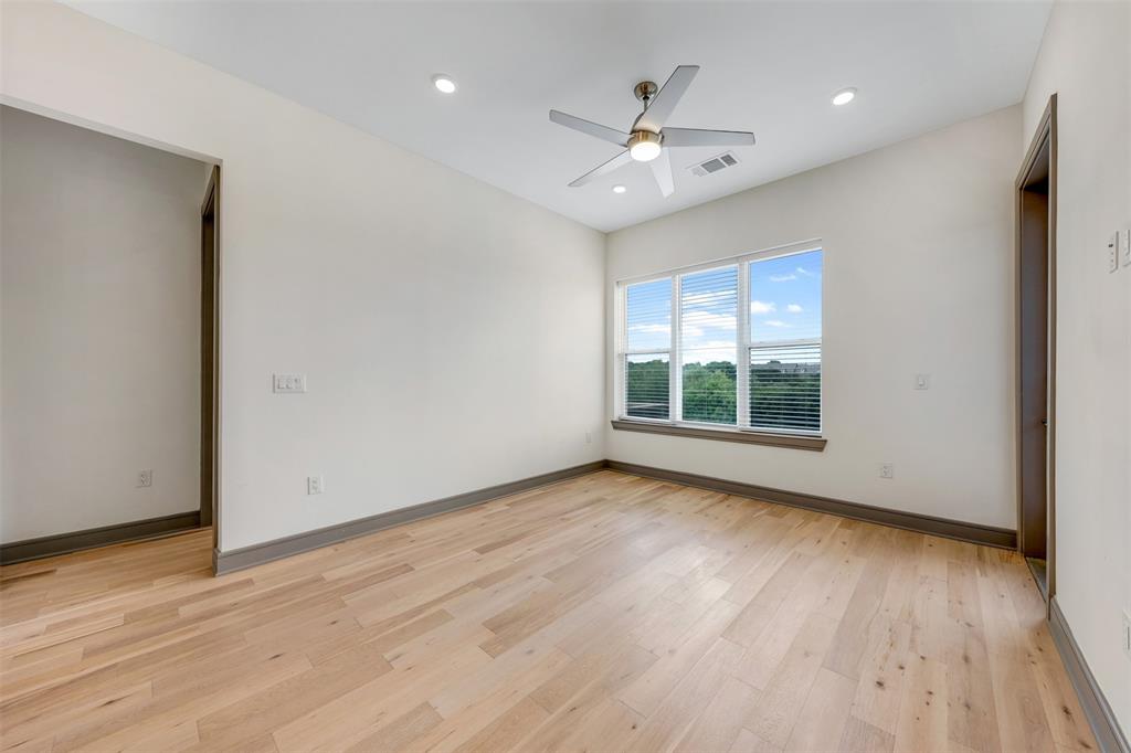2700 Old Denton Road, Unit 2236 Carrollton, TX 75007 - Photo 10 of 28 a view of an empty room with wooden floor and a window
