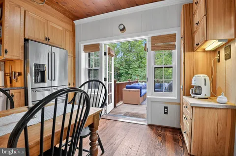 a view of a hallway with wooden floor and windows
