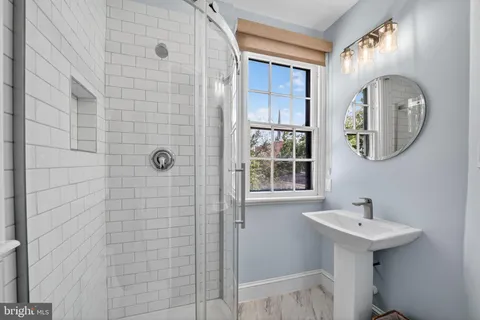a bathroom with a sink a mirror and a shower