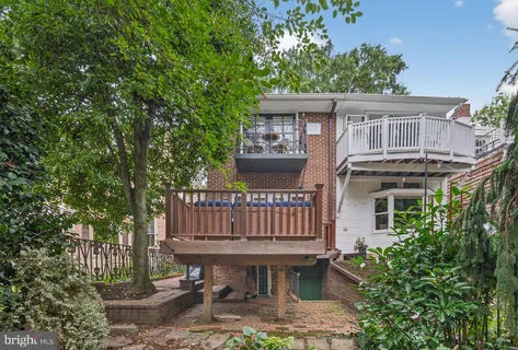 a roof deck with table and chairs