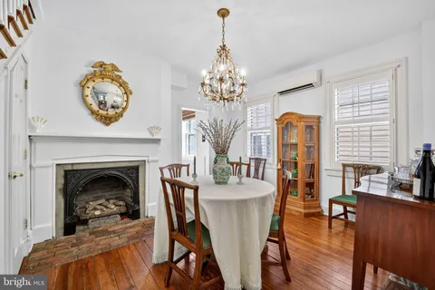 a living room with furniture a fireplace and a chandelier