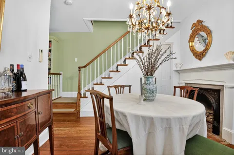 a view of a dining room with furniture wooden floor and a chandelier