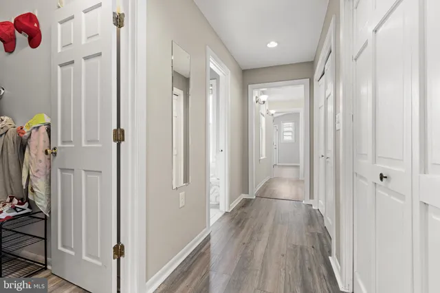 a view of hallway with wooden floor