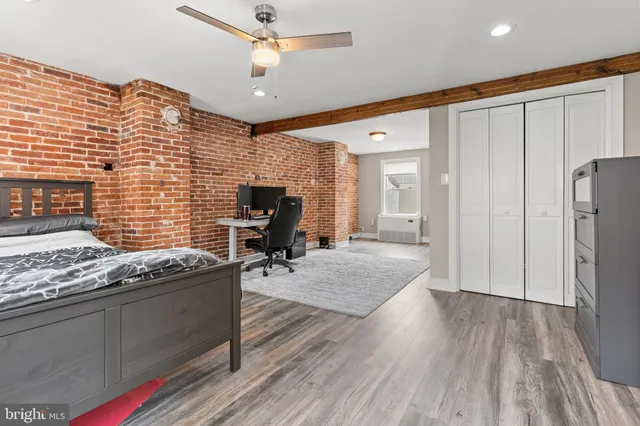 a open kitchen with stainless steel appliances granite countertop a stove refrigerator and wooden floor