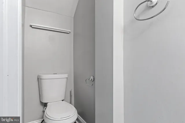 a white toilet sitting next to a bathroom sink