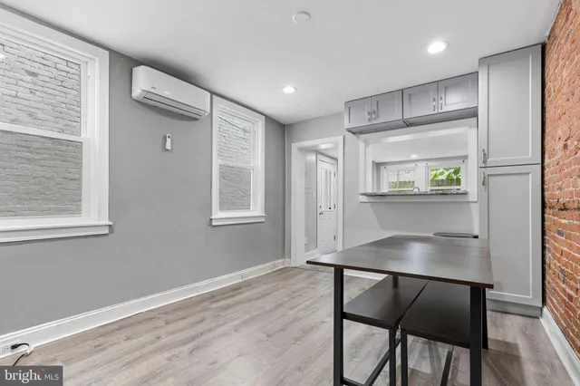 a room with wooden floor and windows