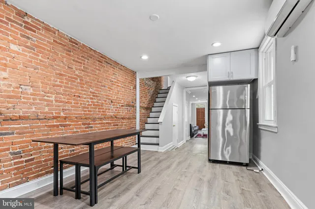a view of a hallway with wooden floor and entryway