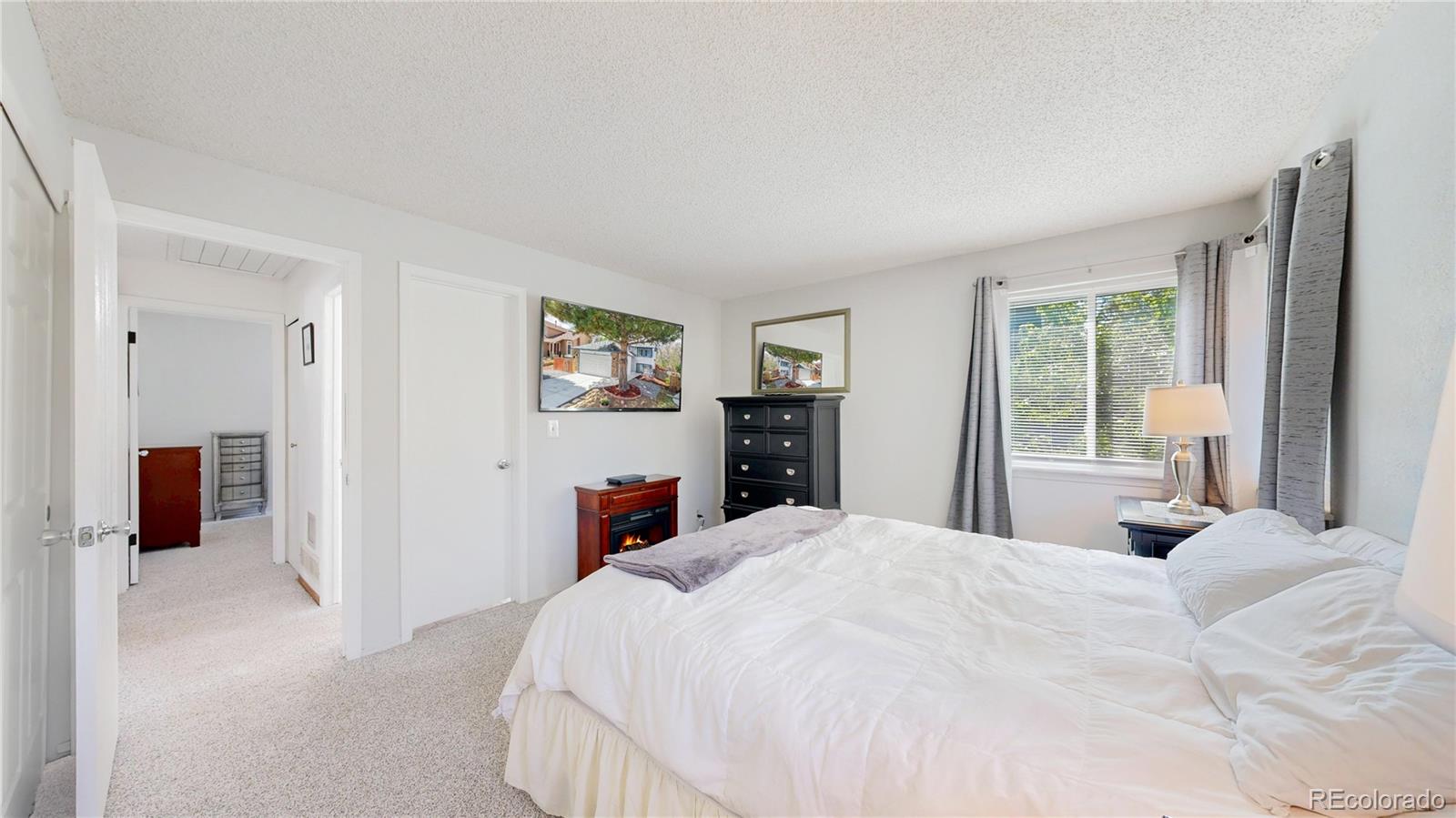 3663 South Flanders Street Aurora, CO 80013 - Photo 11 of 31 a large white bed in a white room