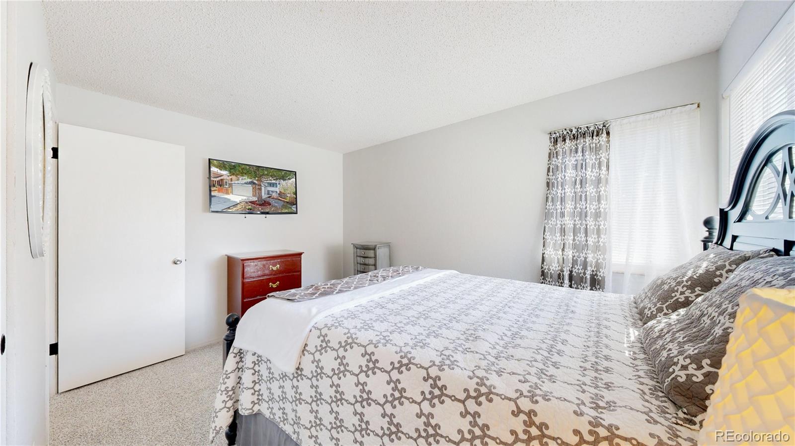 3663 South Flanders Street Aurora, CO 80013 - Photo 14 of 31 a bedroom with a bed and a painting on the wall