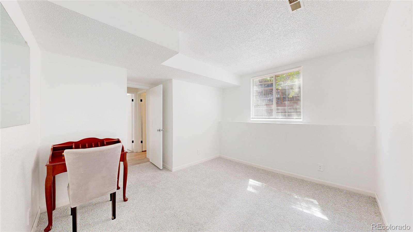 3663 South Flanders Street Aurora, CO 80013 - Photo 20 of 31 a view of a room with furniture and wooden floor