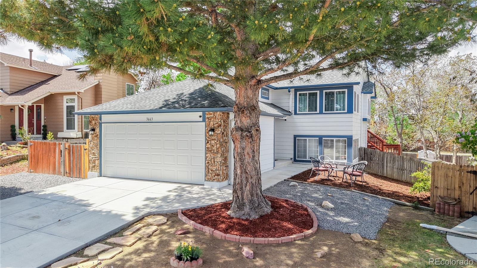 3663 South Flanders Street Aurora, CO 80013 - Photo 2 of 31 a front view of a house with a tree