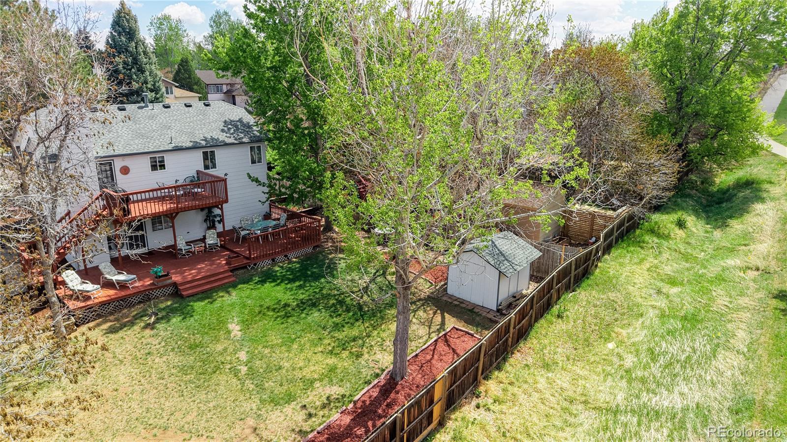 3663 South Flanders Street Aurora, CO 80013 - Photo 26 of 31 a view of a backyard with plants and a lake view