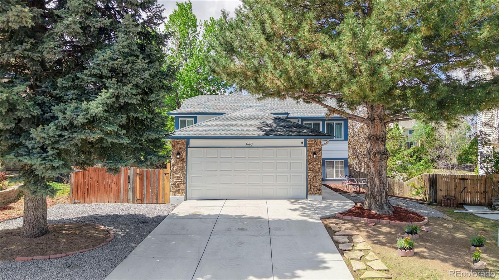 3663 South Flanders Street Aurora, CO 80013 - Photo 28 of 31 a front view of a house with a yard and trees