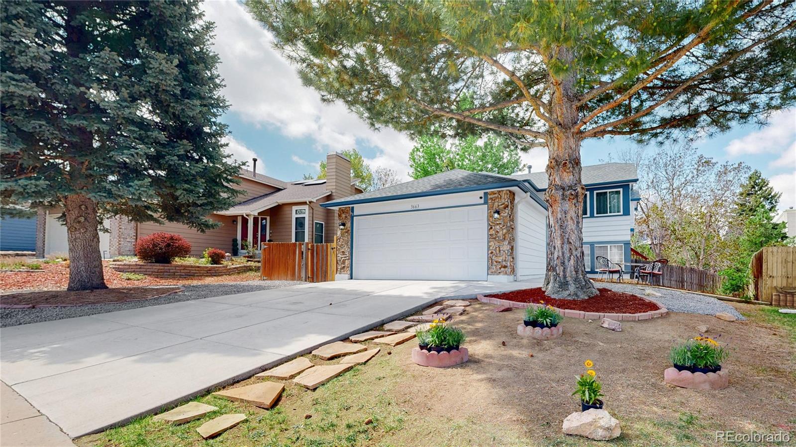 3663 South Flanders Street Aurora, CO 80013 - Photo 29 of 31 a front view of house with yard outdoor seating and trees in the background