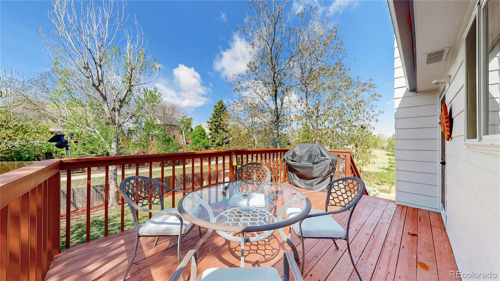 3663 South Flanders Street Aurora, CO 80013 - Photo 7 of 31 a view of a balcony with table and chairs