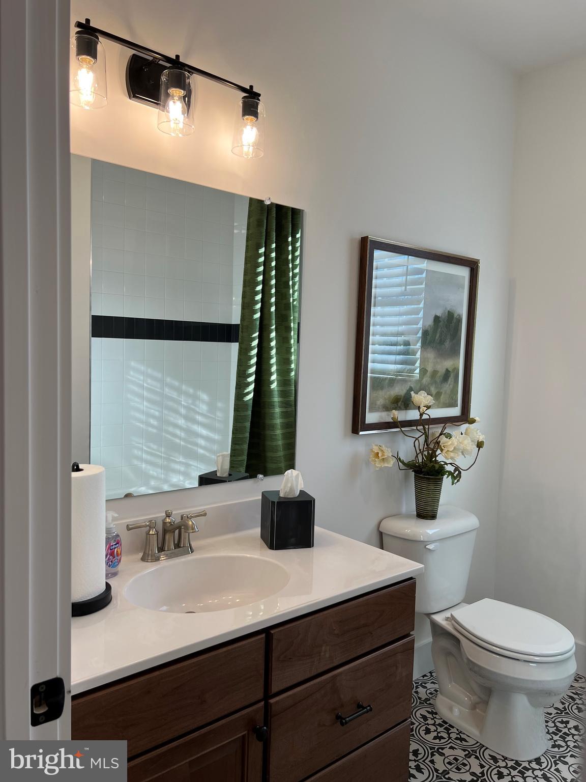 111 Onyx Drive, Unit 55 Hanover, PA 17331 - Photo 10 of 12 a bathroom with a toilet sink and mirror