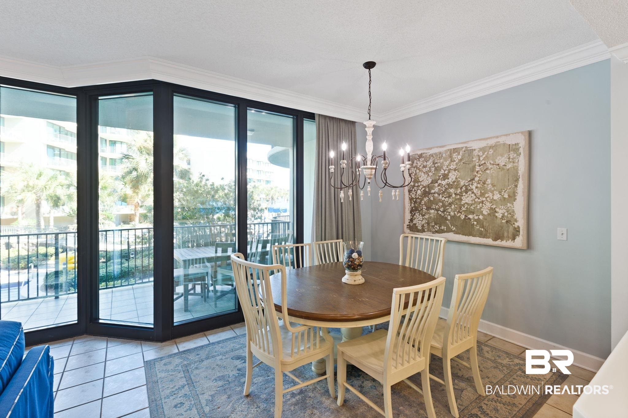 27580 Canal Road, Unit 1112 Orange Beach, AL 36561 - Photo 13 of 50 Dining area with crown molding, light tile patterned floors, and a chandelier