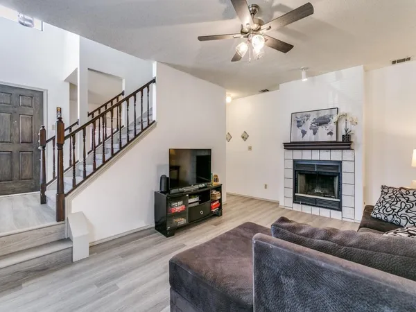 a living room with furniture a flat screen tv and a fireplace