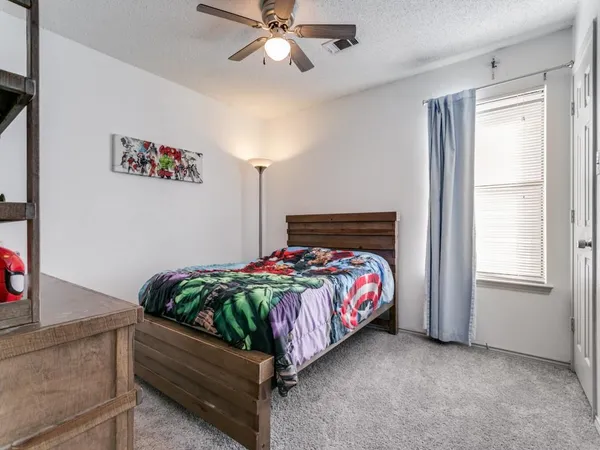 a bed room with a bed and a chandelier