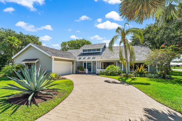 a front view of a house with a garden and entryway