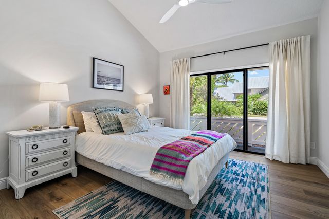 a bedroom with a bed and a dresser next to a window