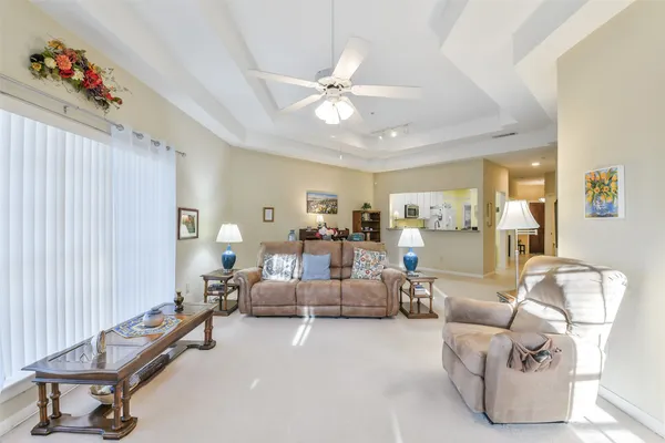 a living room with furniture and a chandelier