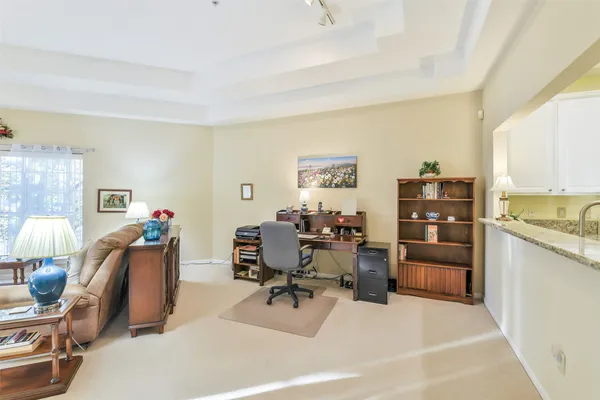 a view of a livingroom with furniture and a window