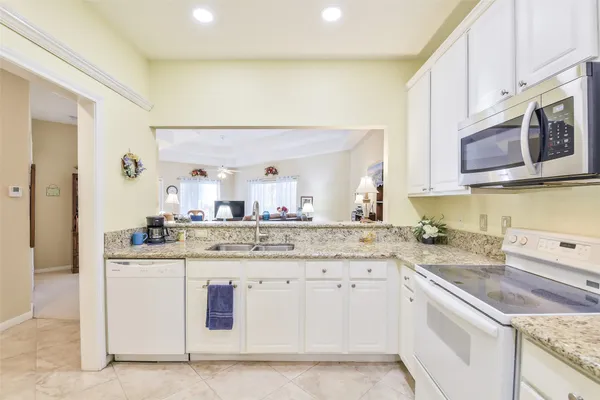 a kitchen with stainless steel appliances granite countertop a sink and cabinets