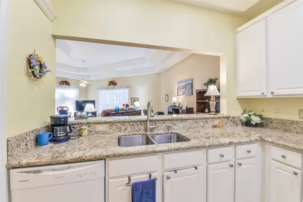 a kitchen with sink and cabinets
