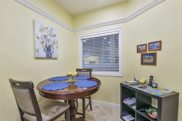 a view of a dining room with furniture and a potted plant