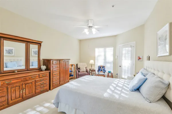 a bedroom with a large bed and a chandelier