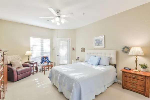 a bedroom with bed and a chandelier