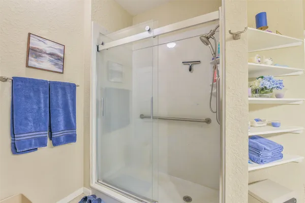 a bathroom with a shower and a sink
