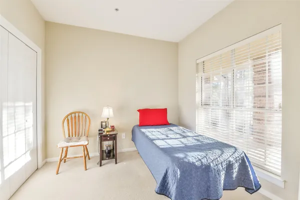 a bedroom with a bed and a painting on the wall