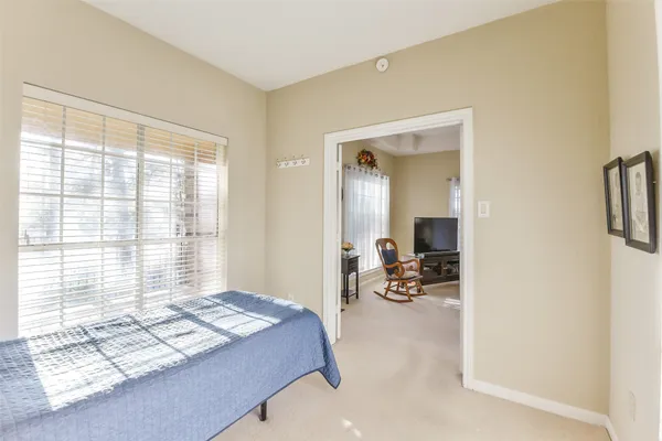 a bedroom with furniture and a window
