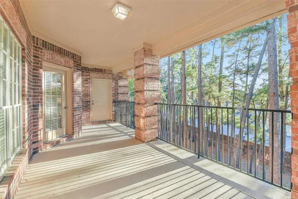 a view of a balcony from a floor to ceiling window