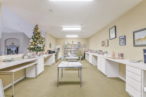 a large white kitchen with kitchen island a sink stove and white cabinets