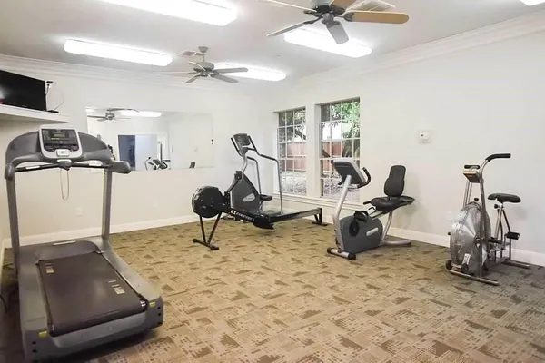 a room with gym equipment and a view of living room