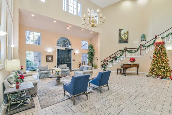 a living room with furniture and a chandelier