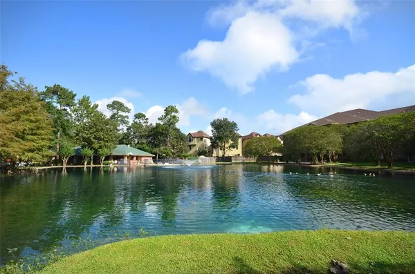 a view of a lake with houses in the back