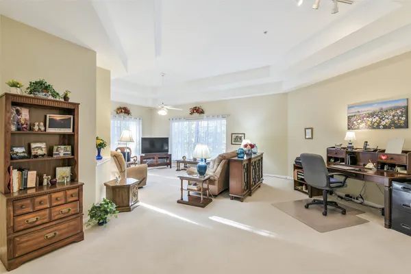 a view of a livingroom with workspace and a couch