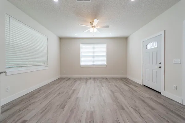 wooden floor in an empty room with a window