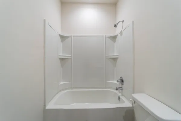 a bathroom with a bathtub and shower